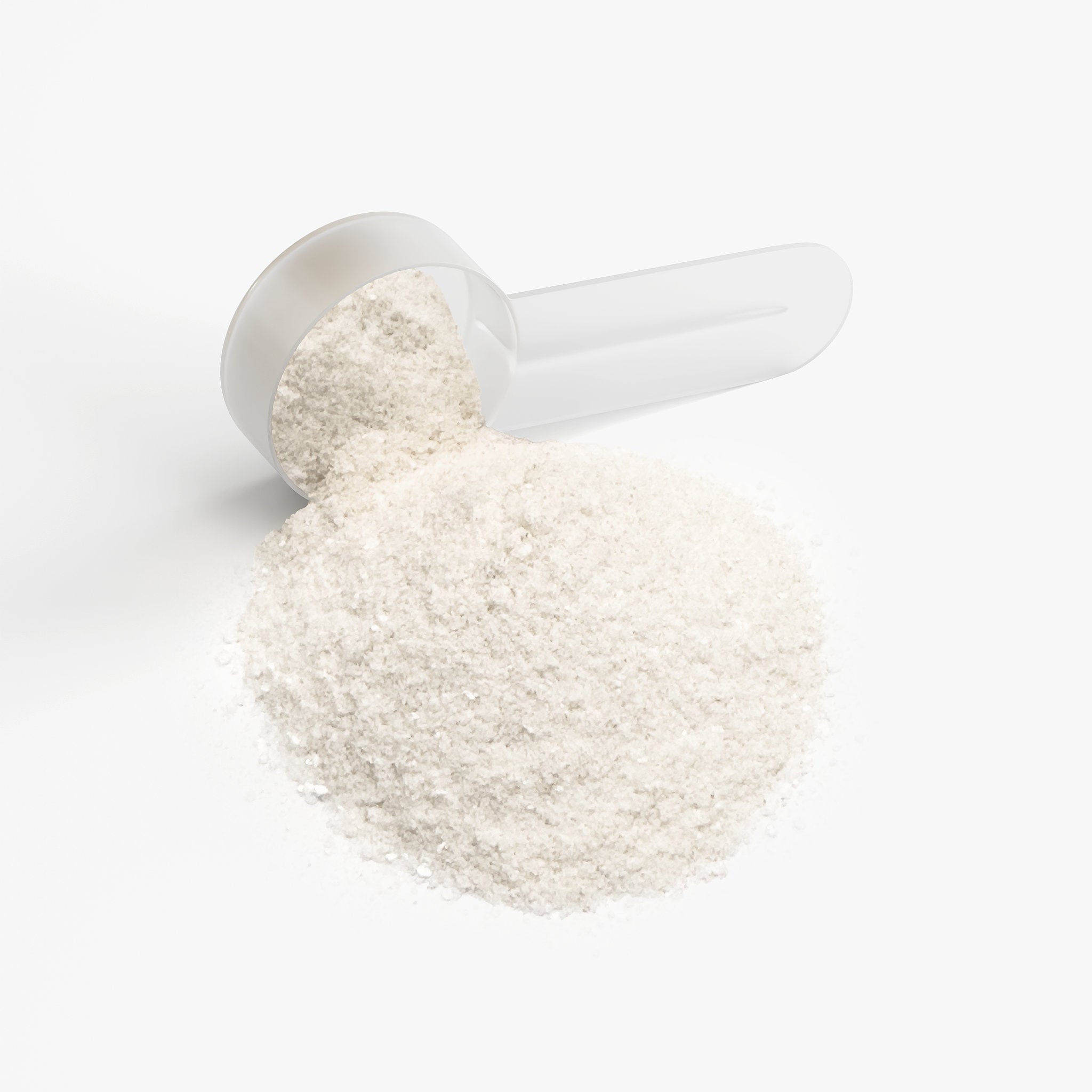 White powder spilling out of a clear plastic scoop on a white background