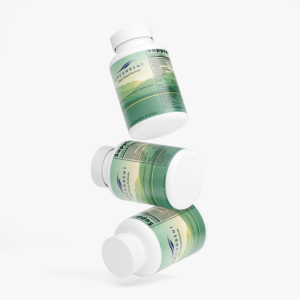 Three white supplement bottles with green labels on a white background