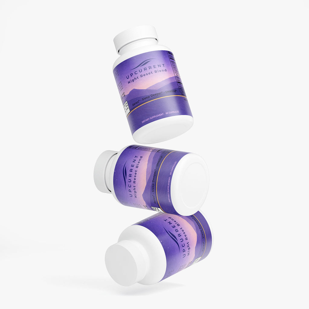 Three purple and white Upcurrent Night Reset Blend supplement bottles on a white background