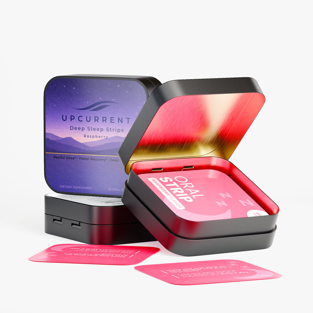 Open black tin containing Upcurrent deep sleep strips with pink strips on a white background