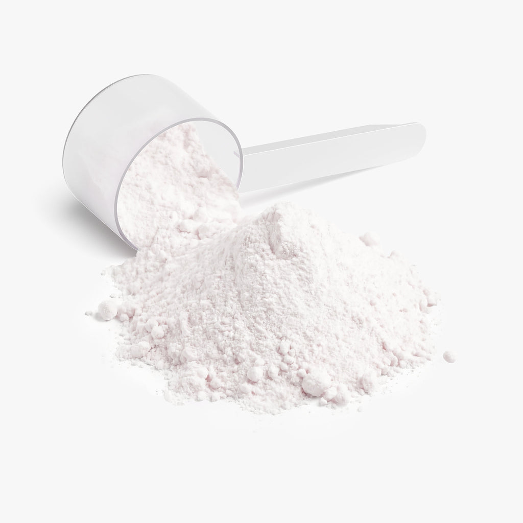 White scoop with  powder on a white background